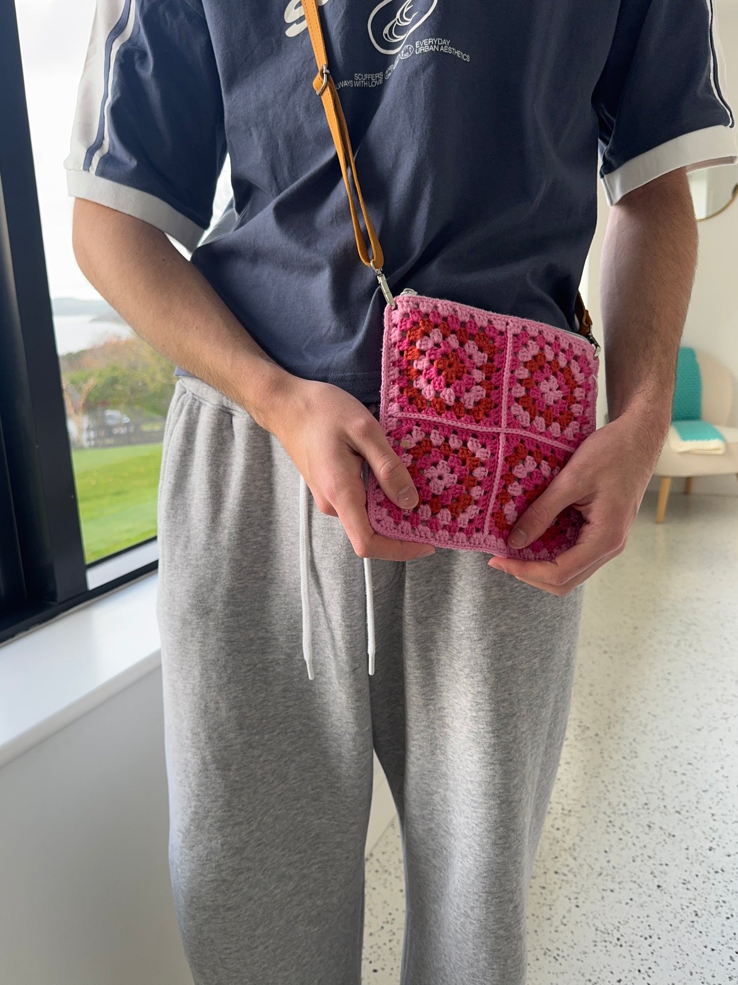 Handmade crocheted lined bag with genuine handmade leather strap.