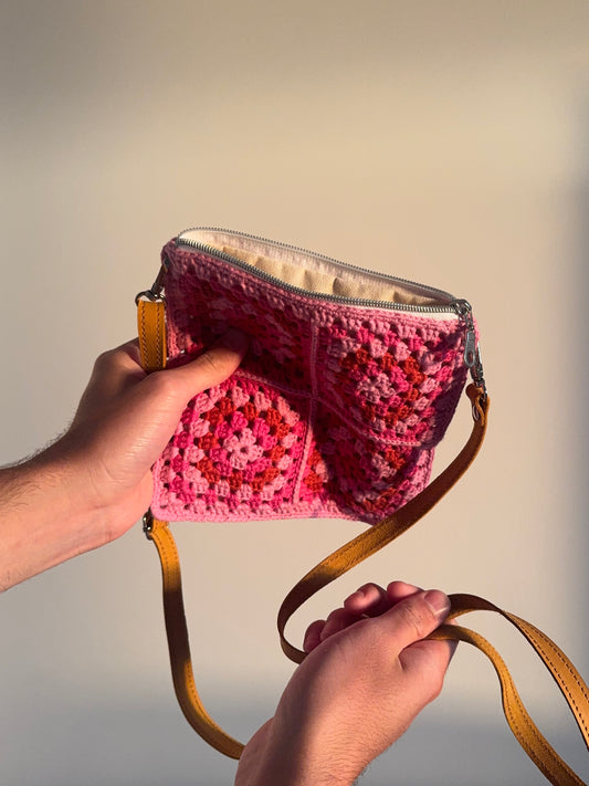 Handmade crocheted lined bag with genuine handmade leather strap.