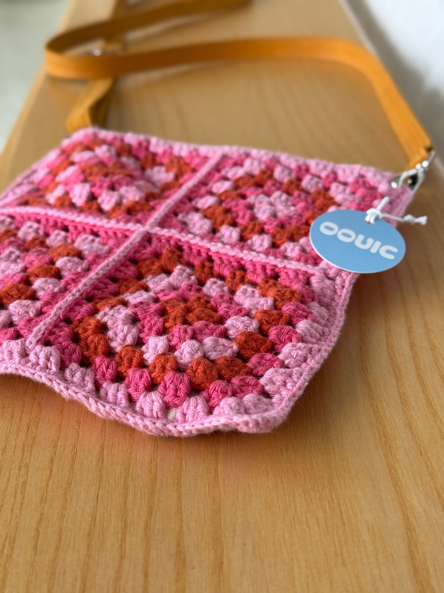 Handmade crocheted lined bag with genuine handmade leather strap.