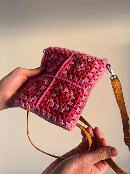 Handmade crocheted lined bag with leather strap.