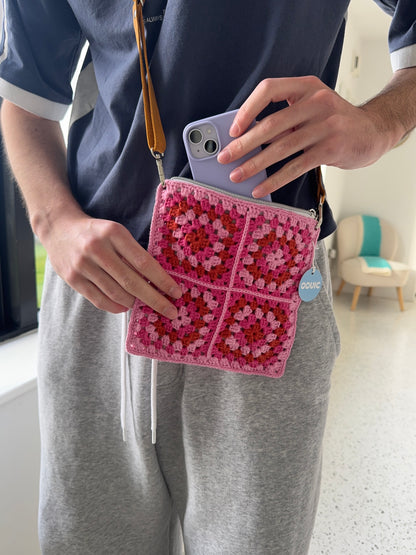 Handmade crocheted lined bag with genuine handmade leather strap.