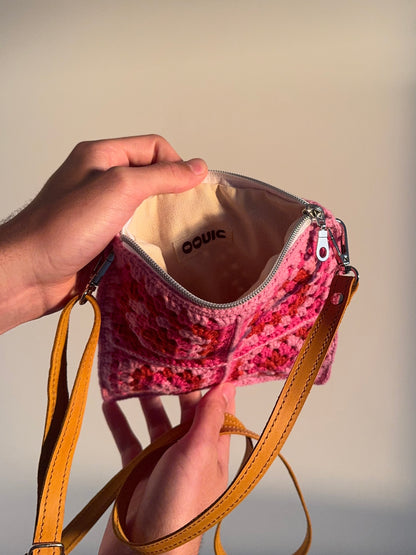 Handmade crocheted lined bag with leather strap.