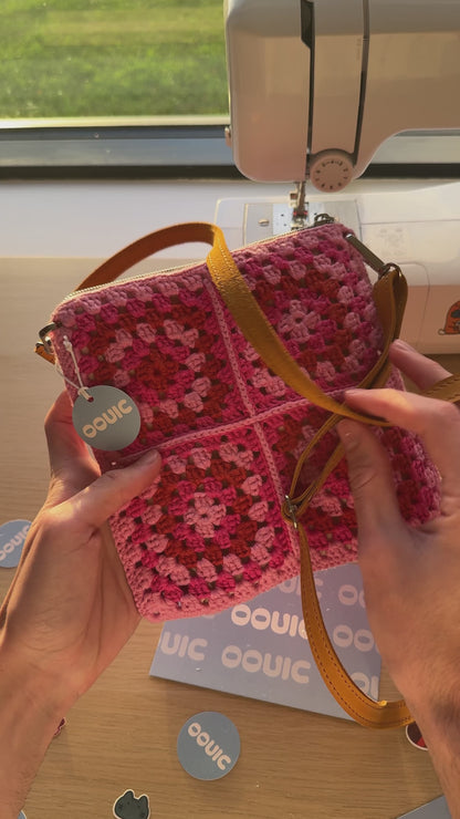 Handmade crocheted lined bag with genuine handmade leather strap.